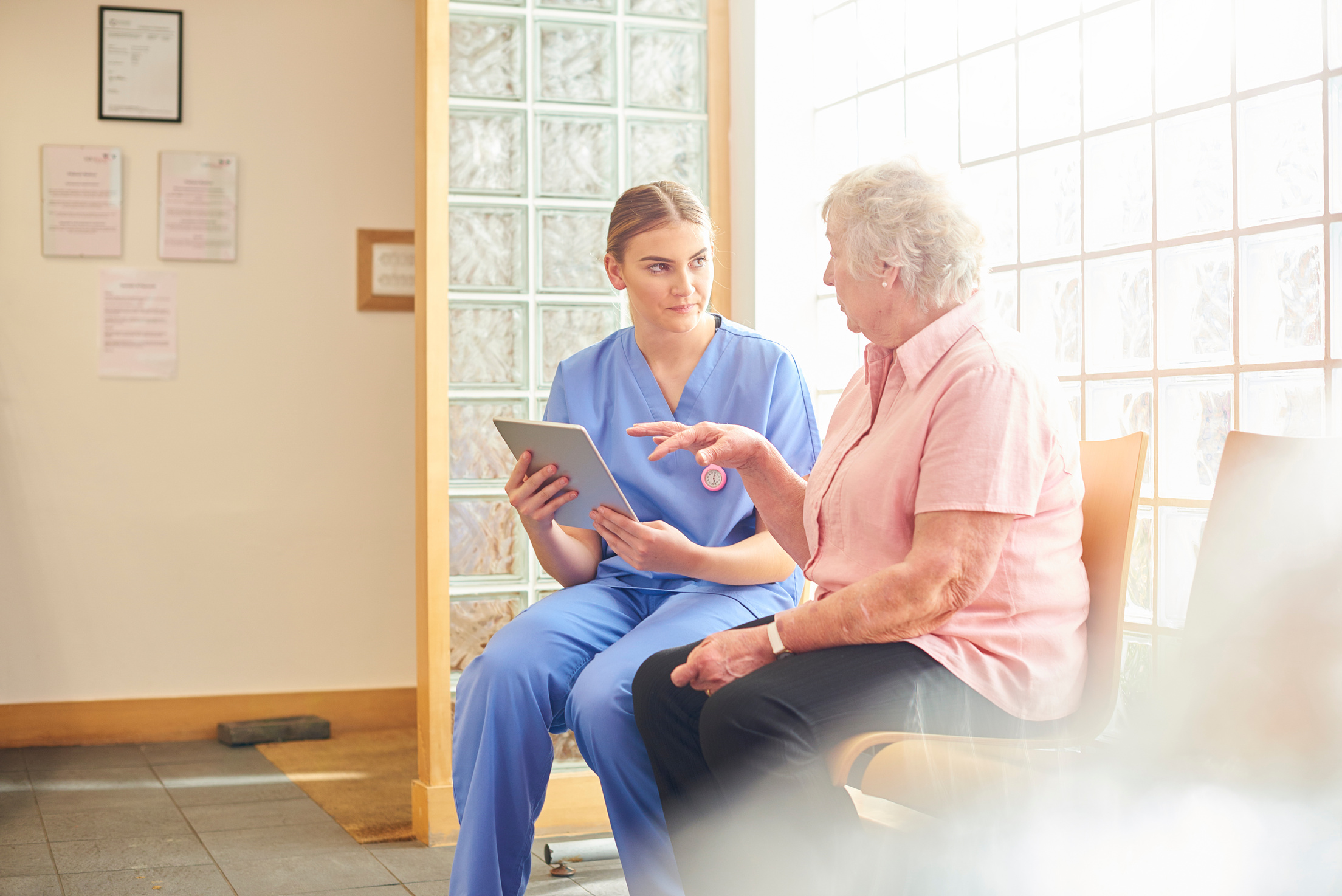 Nurse and patient in medical clinic waiting room